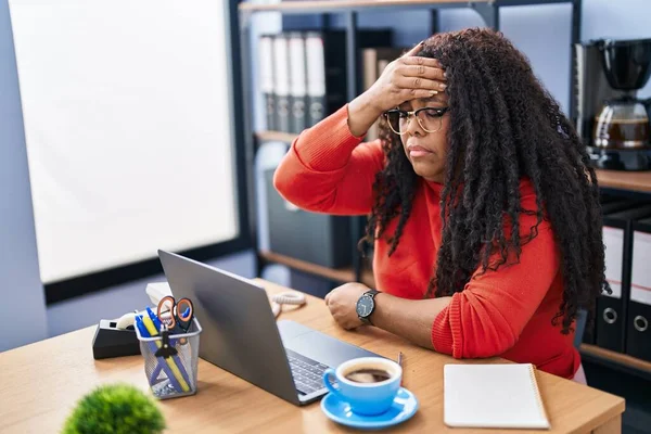 African american woman business worker using laptop suffering for headache at office