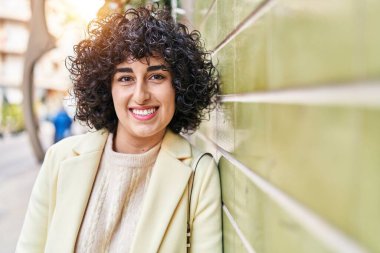 Young middle east woman excutive smiling confident standing at street