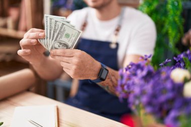 Çiçekçiye para sayan İspanyol bir çiçekçi.