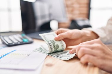 Young blonde woman counting dollars at street