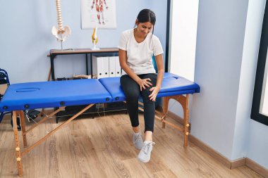 Fizyoterapi kliniğinde dizinden yaralanan genç Latin kadın hasta.