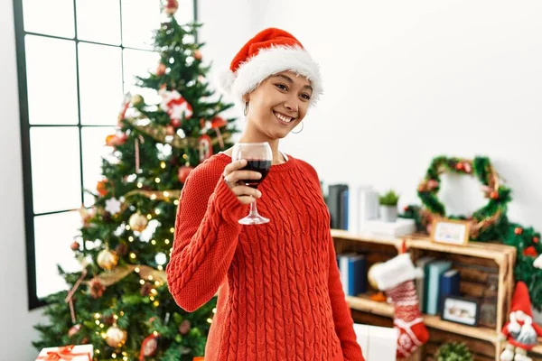 Young Hispanic Woman Toasting Wine Standing Christmas Tree Home —  Fotos de Stock