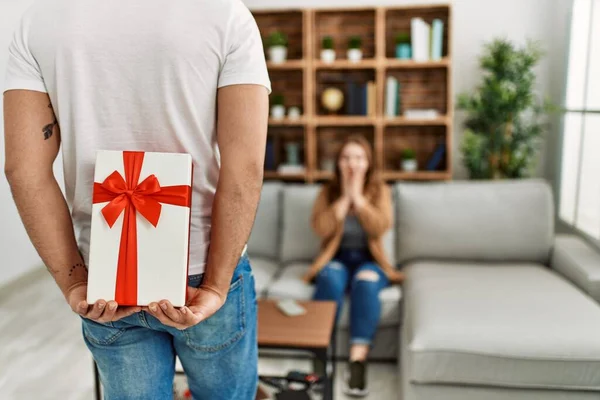Young Couple Smiling Happy Sitting Sofa Surprise Anniversary Gift Home — Stock Photo, Image