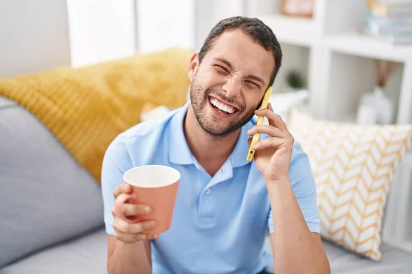 Young Man Drinking Coffee Talking Smartphone Home — Stockfoto