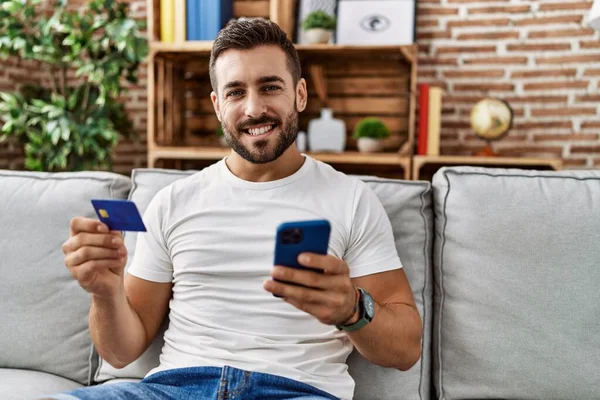Young Hispanic Man Smiling Confident Using Smartphone Credit Card Home — Foto Stock