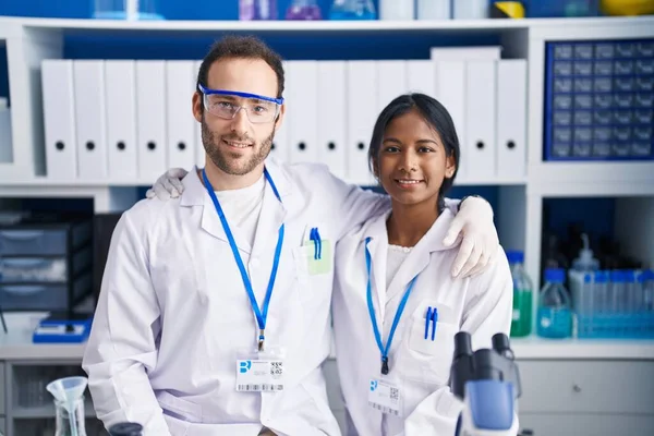 Interracial Couple Working Scientist Laboratory Looking Positive Happy Standing Smiling — Zdjęcie stockowe