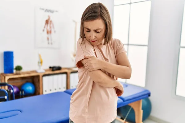 物理治疗诊所对患有手臂疼痛的中年惊慌失措妇女进行治疗 — 图库照片
