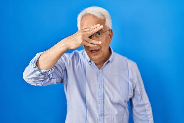 Hispanic Senior Man Wearing Glasses Peeking Shock Covering Face Eyes — Photo