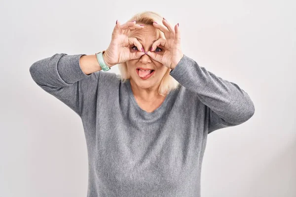 Middle Age Caucasian Woman Standing White Background Doing Gesture Binoculars — Stock Photo, Image