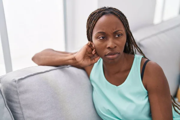 African American Woman Sitting Sofa Serious Expression Home — Photo