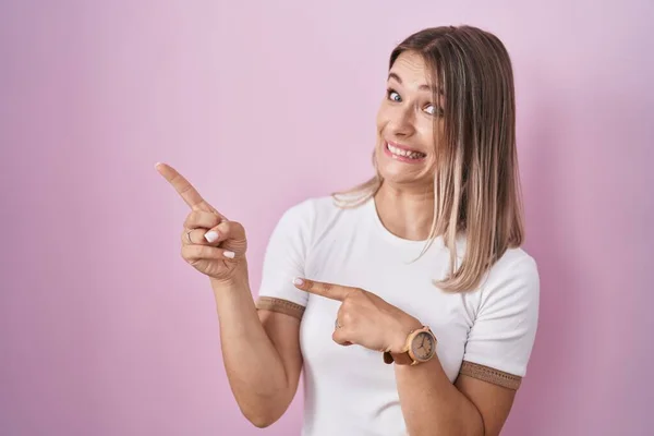 Blonde Caucasian Woman Standing Pink Background Pointing Aside Worried Nervous — 스톡 사진