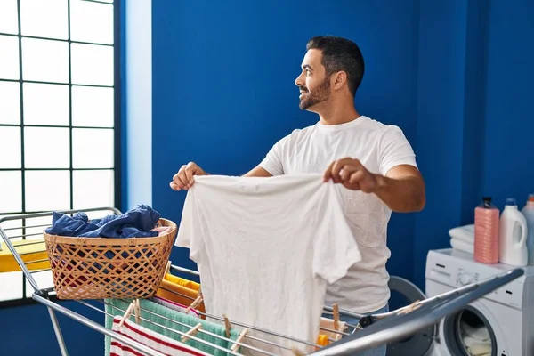 Young Hispanic Man Smiling Confident Hanging Clothes Clothesline Laundry Room — ストック写真