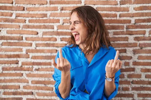 Beautiful Brunette Woman Standing Bricks Wall Showing Middle Finger Doing — стоковое фото