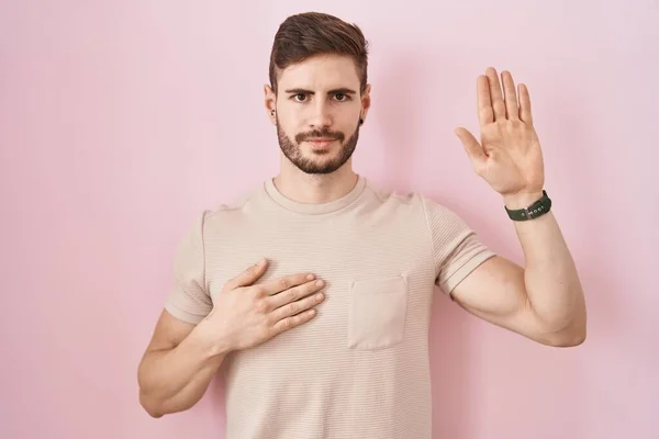 Hispanic Man Beard Standing Pink Background Swearing Hand Chest Open — Zdjęcie stockowe