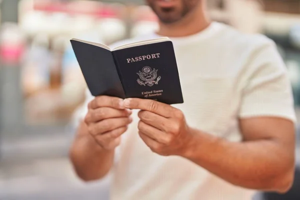 Молодой Латиноамериканец Улыбается Уверенно Читая Паспорт Улице — стоковое фото