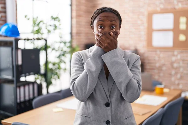 African american woman at the office shocked covering mouth with hands for mistake. secret concept.