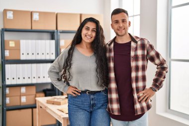 Man and woman ecommerce bussines workers standing together at office