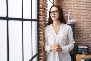 Young woman business worker standing at office