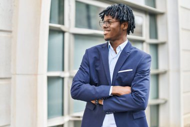 African american man executive smiling confident standing with arms crossed gesture at street