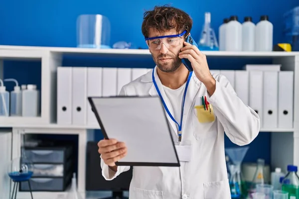 Jonge Man Wetenschapper Praten Smartphone Houden Klembord Het Laboratorium — Stockfoto