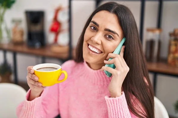 Young Hispanic Woman Drinking Coffee Talking Smartphone Home — Stock fotografie