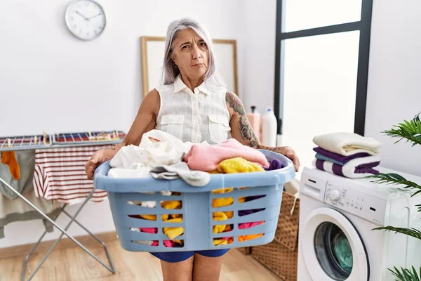 Middle Age Grey Haired Woman Holding Laundry Basket Skeptic Nervous — Stock Photo, Image
