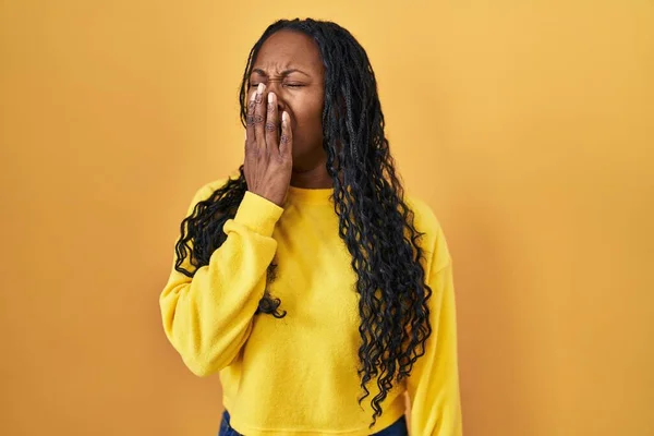African Woman Standing Yellow Background Bored Yawning Tired Covering Mouth — Stock Photo, Image