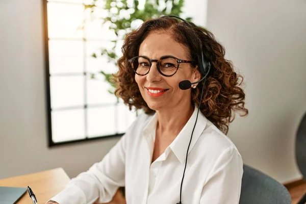 stock image Middle age hispanic woman smiling confident working at office