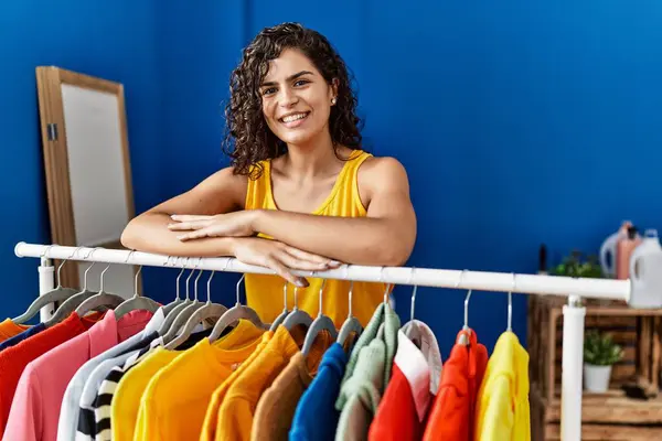 Ung Latin Kvinde Smilende Selvsikker Lænet Tøj Rack Vaskerum - Stock-foto