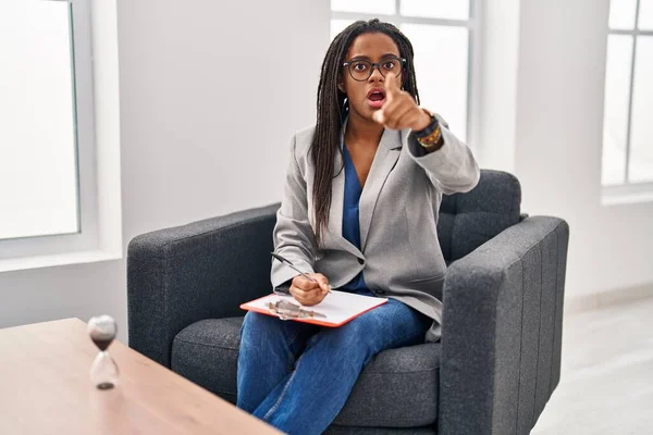 アフリカ系アメリカ人の若者が相談所で働いている指を前に 口を開けて驚いた表情 正面に何か — ストック写真