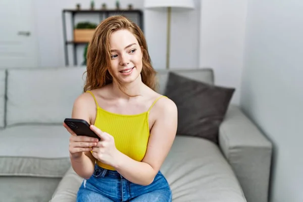 Young Redhead Girl Smiling Happy Using Smartphone Home — Foto de Stock