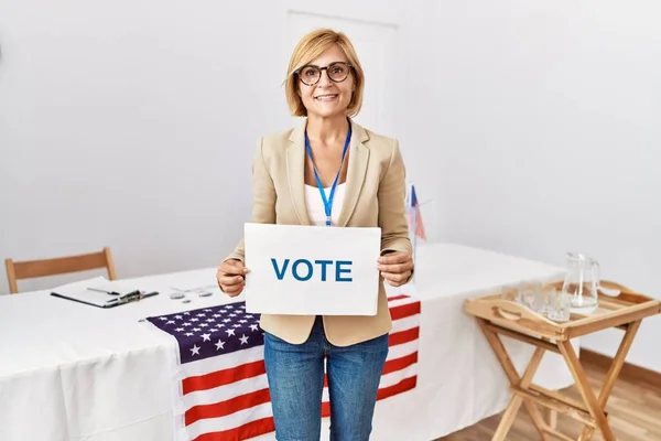 Middle Age Blonde Woman Smiling Confident Holding Vote Banner Electoral — Fotografia de Stock