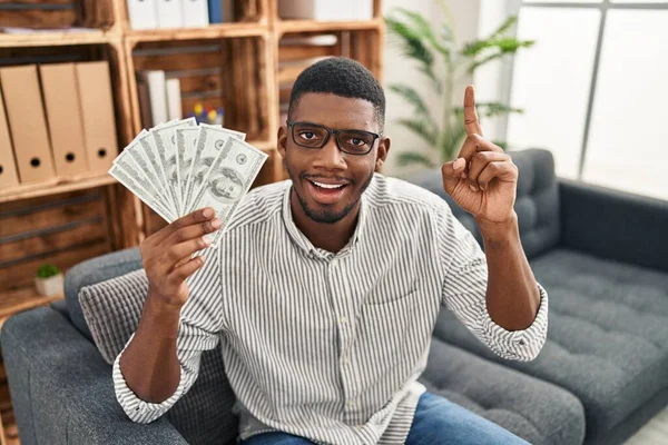African American Man Holding Dollars Surprised Idea Question Pointing Finger — Stockfoto