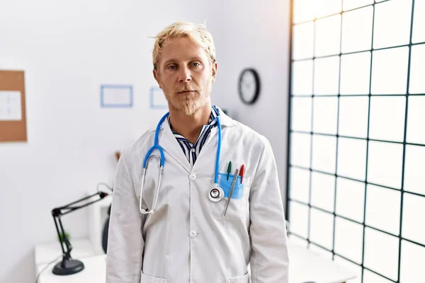 Young Blond Man Wearing Doctor Uniform Stethoscope Clinic Looking Sleepy — ストック写真