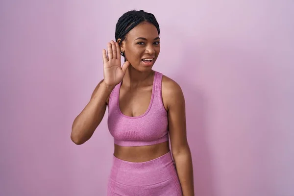 African American Woman Braids Wearing Sportswear Pink Background Smiling Hand — 图库照片