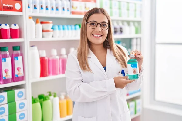 Young Blonde Woman Working Pharmacy Drugstore Holding Syrup Smiling Happy — Zdjęcie stockowe