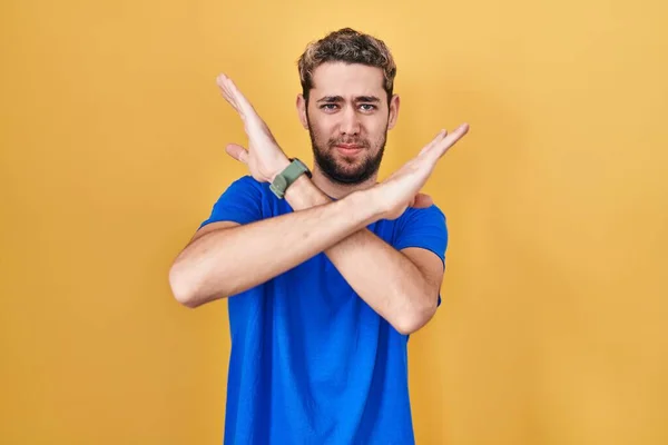Hispanic Man Beard Standing Yellow Background Rejection Expression Crossing Arms — Stockfoto