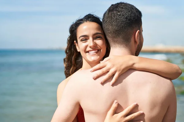 Young Hispanic Couple Tourists Wearing Swimsuit Hugging Each Other Seaside — Fotografia de Stock