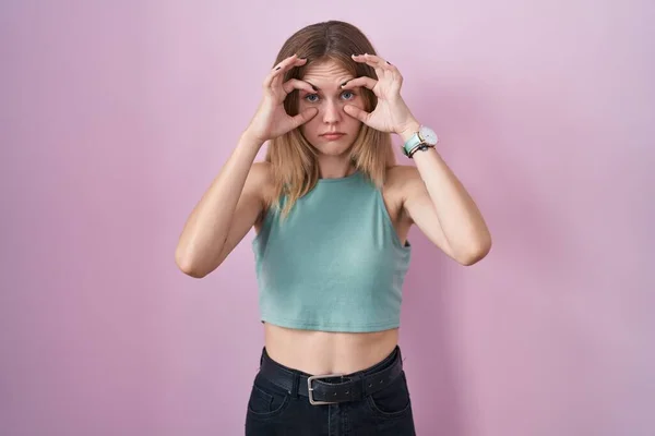Blonde Caucasian Woman Standing Pink Background Trying Open Eyes Fingers — Stock Photo, Image