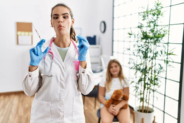 Young Doctor Woman Putting Vaccine Little Girl Making Fish Face — Stockfoto
