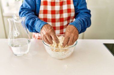 Son sınıf öğrencisi mutfakta hamur pişiriyor.