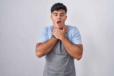 Beyaz arka planda önlük giymiş İspanyol genç bir adam boğularak öldü diye bağırıyor. Sağlık problemi. Boğulma ve intihar konsepti. 