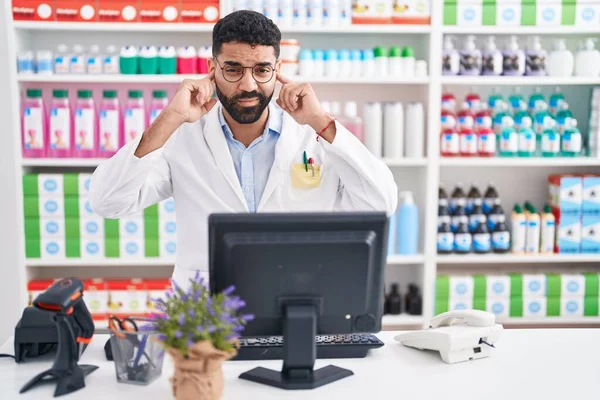 Hispanic Man Beard Working Pharmacy Drugstore Covering Ears Fingers Annoyed — Stockfoto