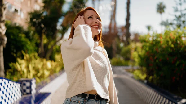 stock image Young redhead woman smiling confident standing at park