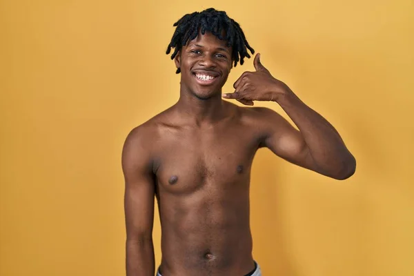 Young African Man Dreadlocks Standing Shirtless Smiling Doing Phone Gesture — Stock Photo, Image