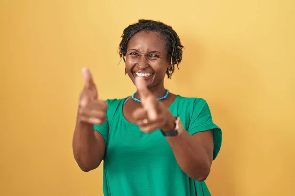 African Woman Dreadlocks Standing Yellow Background Pointing Fingers Camera Happy — Stockfoto