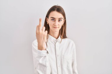 Young caucasian woman standing over isolated background showing middle finger, impolite and rude fuck off expression 