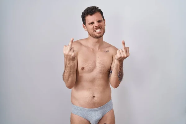 Young Hispanic Man Standing Shirtless Wearing Underware Showing Middle Finger — Zdjęcie stockowe