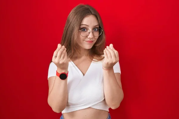 Young Caucasian Woman Standing Red Background Doing Money Gesture Hands — Stock Photo, Image