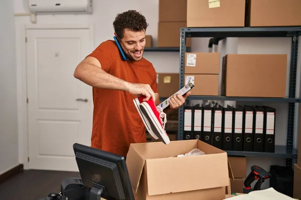 Young Hispanic Man Ecommerce Business Worker Talking Smartphone Packing Sneakers — Stock Photo, Image